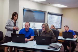 Instructor helping students learn Microsoft 365